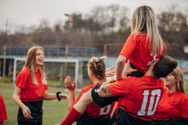 istock Female rugby team celebrating victory 1474851455