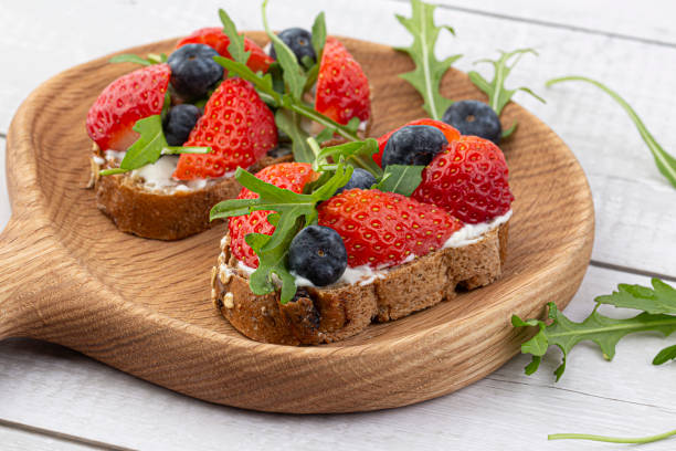 istock Sandwiches with strawberries, arugula and cheese. 1474851496