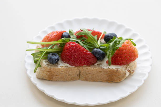 istock Sandwiches with strawberries, arugula and cheese. 1474852005