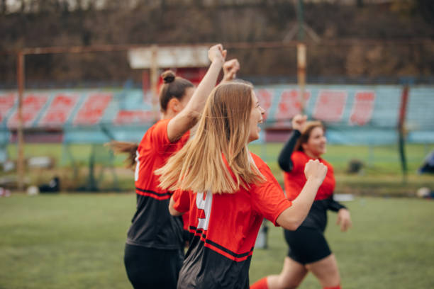 istock Female rugby team celebrating victory 1474852873