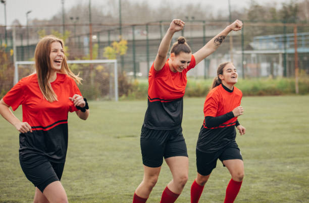 istock Female rugby team celebrating victory 1474852960