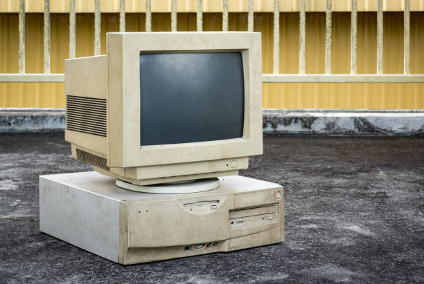 istock old and obsolete computer set on grunge concrete floor with yellow fence at back 1474855382