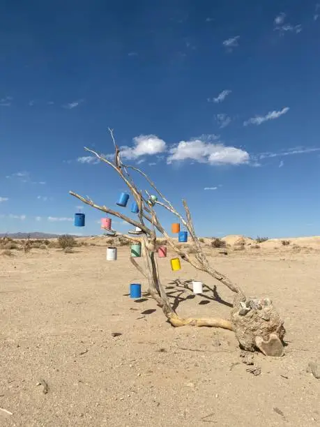 Paint cans displayed on a tree