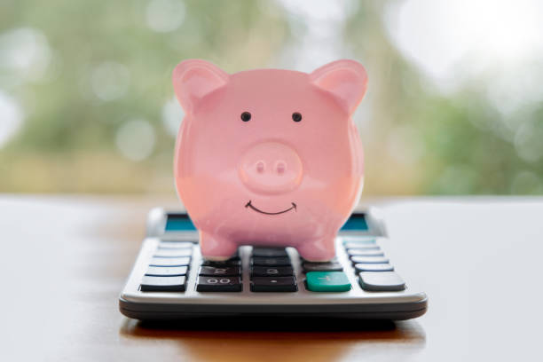 istock Piggy bank and calculator 1474856884