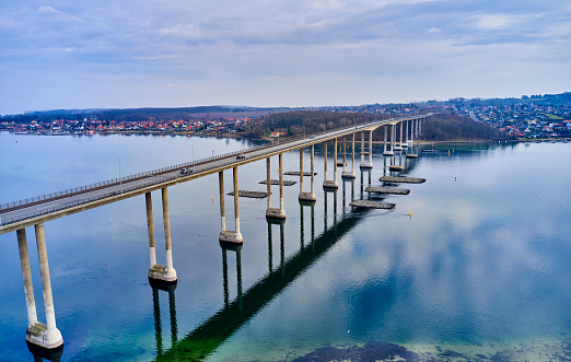 Svendborgsund Bridge from drone point of view. Sky is reflected in the smooth water