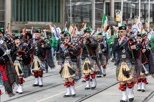 Toronto, Canada - March 19, 2023 : Laborers' International Union of North America (LiUNA) pipe band marching in the annual St Patrick's Day parade down Queen Street