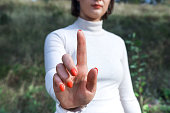 Mockup photo for woman pressing something with her index finger. Hand with a raised finger as an attention gesture.