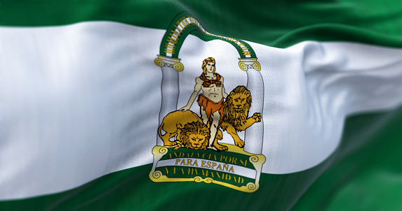 The Andalusia flag waving. Three horizontal stripes: green, white and green. Coat of arms superimposed on the central stripe. Selective focus. 3d illustration render. Close-up. Textured background