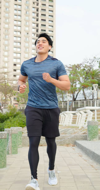 istock asian man jogging in city 1474860606