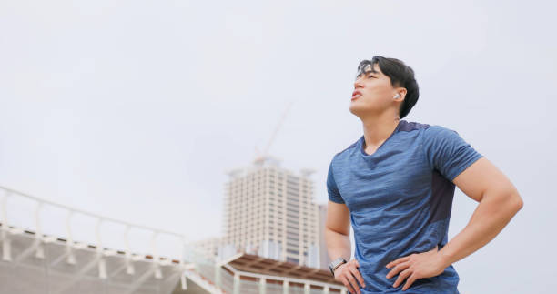 istock asian man jogging in city 1474860656