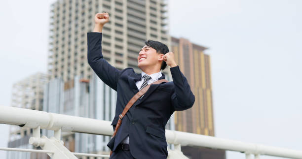istock businessman raise his arms 1474861044