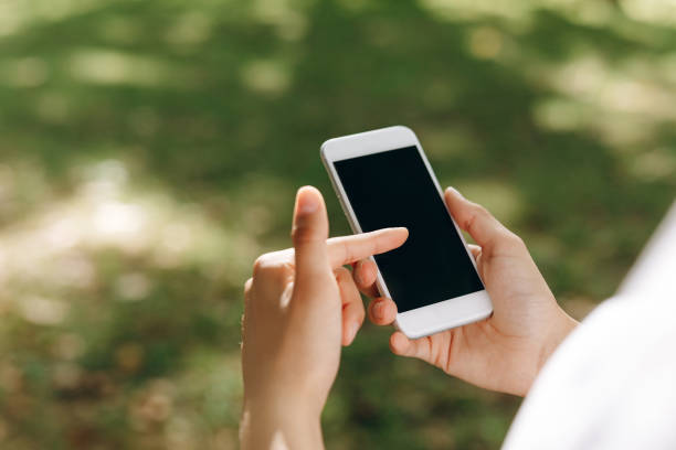 istock A female is walking and doing something with a phone. 1474861128