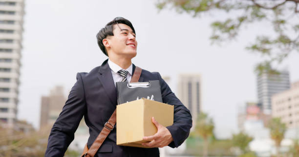 happy man quit his job asian happy businessman quit his job and walk in city with box - fist gesture day 1 stock pictures, royalty-free photos & images