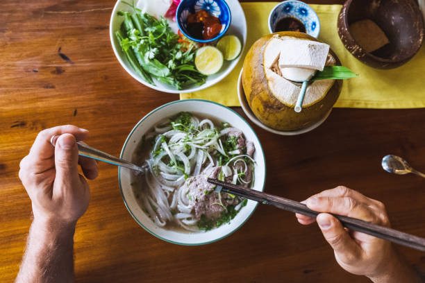 bowl of pho soup on wooden table