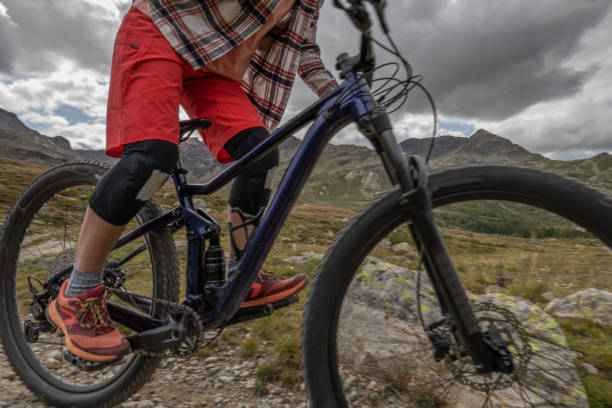 istock Unrecognisable mountain biker descending trail in the Alps 1474862820