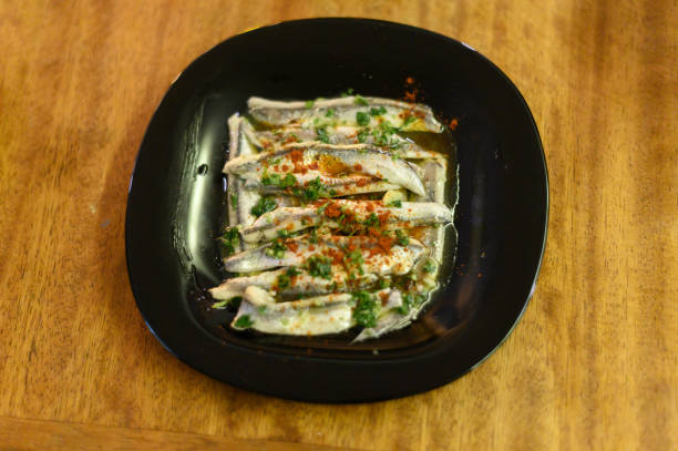 Top view photo of fish marinated in parsley and olive oil. Spanish gastronomy