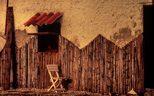 wooden chair in front of a rustic wall in the countryside