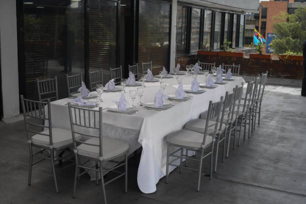 restaurant tables set up for an event party or wedding reception - banquet table set restaurant imagens e fotografias de stock