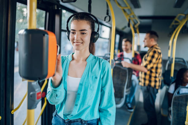 istock Woman riding in a bus and using a smartphone for paying a ticket 1474864610