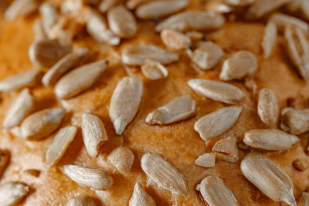 istock Sunflower seeds on baked bread crust close-up, selective focus 1474864837