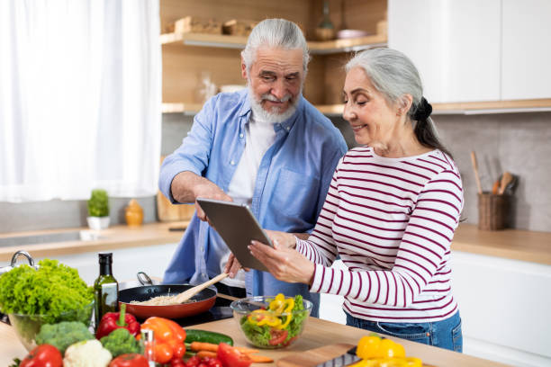 istock Online Recipe. Happy Senior Couple Using Digital Tablet In Kitchen Together 1474864990