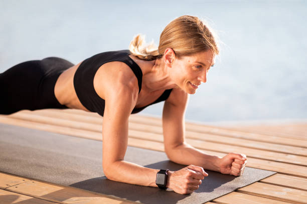 istock Outdoor Workout. Sporty Middle Aged Woman Doing Elbow Plank Exercise 1474865017