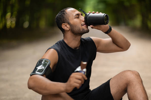 istock Tired middle eastern sportsman having snack while training outdoors 1474866957