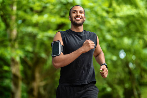 istock Motivated middle eastern sporty guy jogging outdoors 1474866965