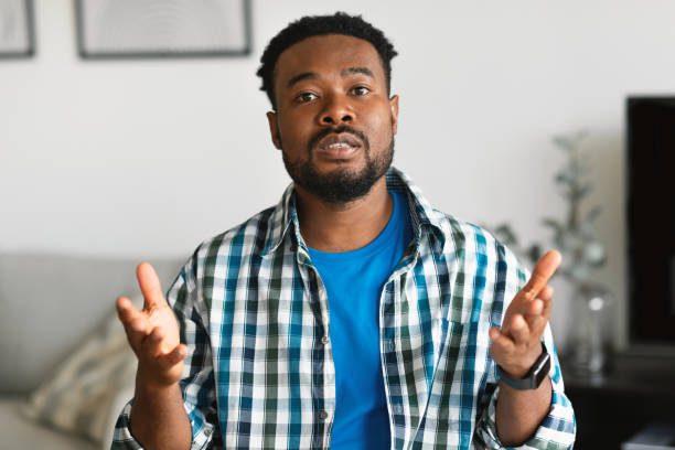 istock Serious Bearded African American Man Talking Communicating Sitting At Home 1474866971