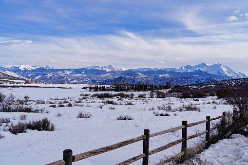 Elk Mountain View in Winter - Scenic winter landscape in rural setting with rugged peaks of the West Elk Mountains in background. Roaring Fork Valley, Colorado USA.