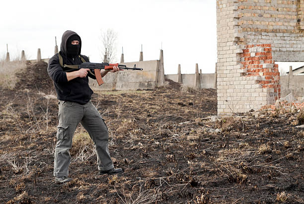 istock Man in mask with gun 147486722