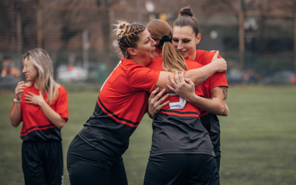 istock Female rugby team celebrating victory 1474867302