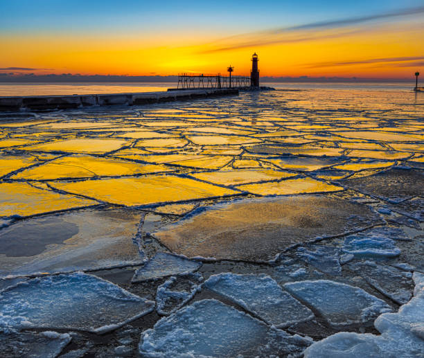 istock Amazing icy Winter scene in harbor by lighthouse 1474867439