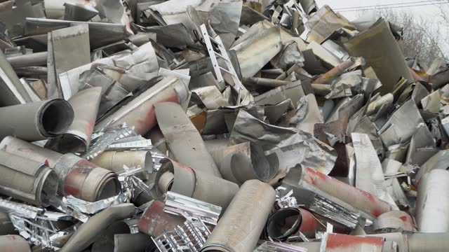 A pile of aluminum waste for recycling. The concept of secondary resources development.