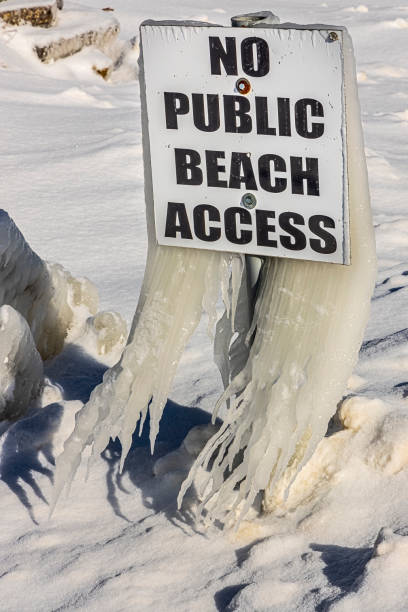 istock Beach sign covered in long icicles 1474868354