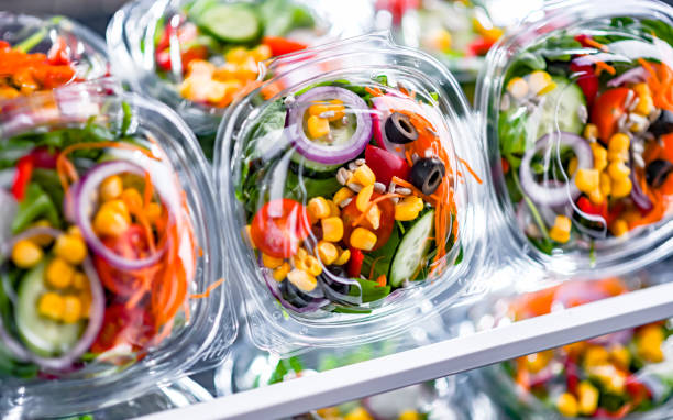 istock Boxes with pre-packaged vegetable salads in a commercial fridge 1474873541