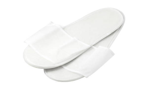 istock Disposable white pair slippers, isolated on light background with clipping path 1474873981