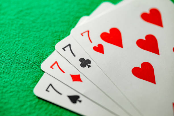 istock Playing cards, poker combination four of kind, quads, sevens of different suits, same value 1474875107
