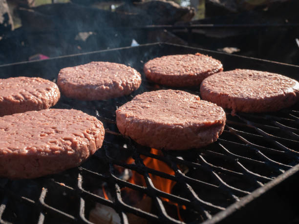 istock Ground beef patties on the grill over an open fire 1474876047