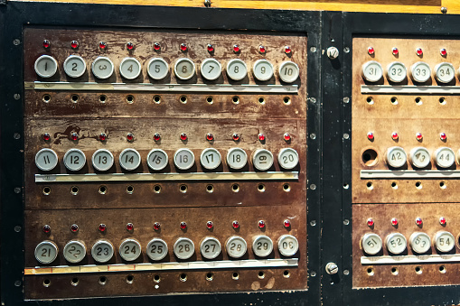 Panel with numbers and bulbs marked with numbers for manual switching of the telephone line. Old telephone exchange.