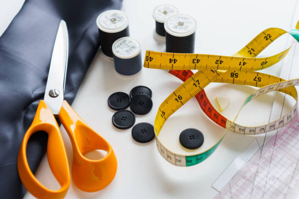 istock Sewing items and seamstress tools. Tailoring scissors, measuring tape, threads, buttons, fabric 1474880168