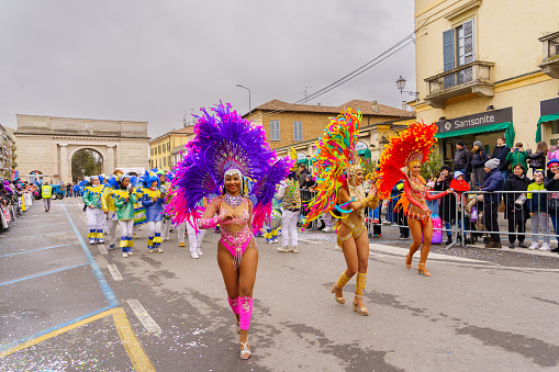 Crema, Italy - February 26, 2023: Carnival parade, with dancers in costumes, and crowd, in Crema, Lombardy, Northern Italy
