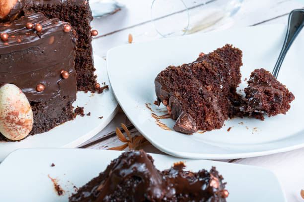 istock Slice of chocolate cake with dark ganache filling next to a fork_side view. 1474883123
