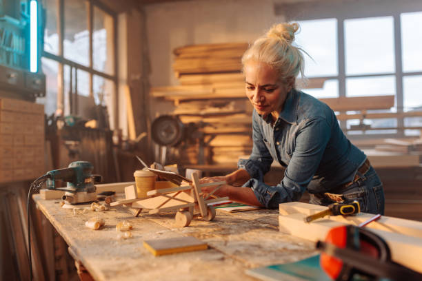istock Female carpenter building toy. 1474885407