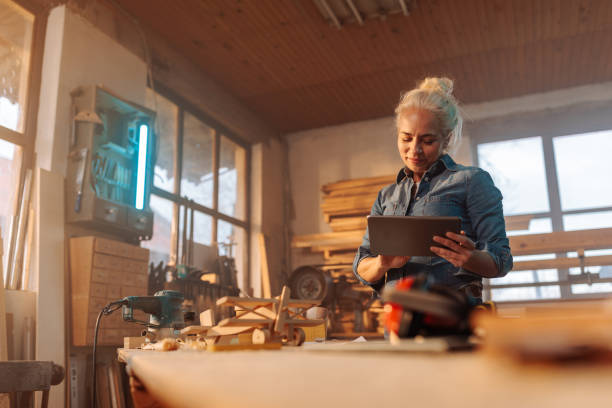 istock Female designer in wood workshop. 1474885415