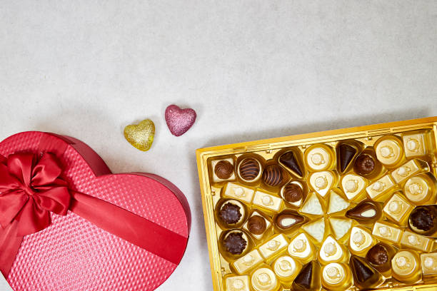 istock chocolate pieces from various type in box for valentine's day with red heart shaped box 1474885691