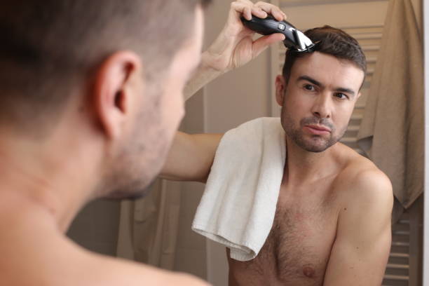 istock Man cutting his own hair 1474887029