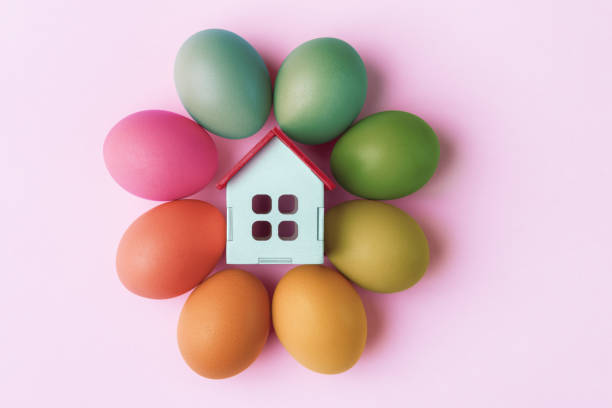 istock Decorative house and Easter eggs on pink background. Easter holiday greeting concept 1474888505
