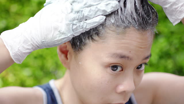 Asian woman dying hair at home