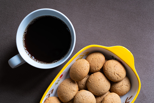 A cup of coffee and cookies.